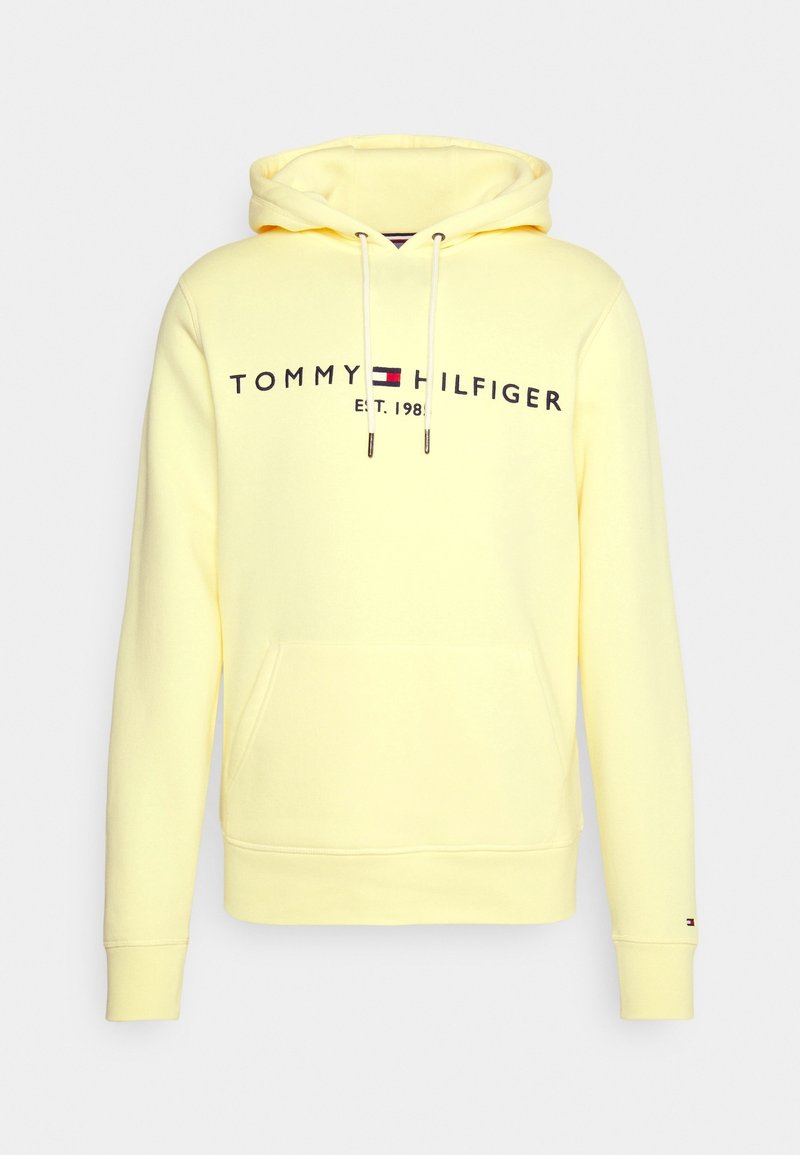 Felpa leggera gialla di Tommy Hilfiger con tasca frontale, cordini bianchi e logo con emblema della bandiera sul petto.