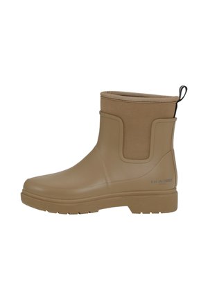 Botas de tobillo de goma beige con una textura suave, paneles laterales elásticos y una pestaña de agarre. Presenta una suela estriada y un sutil logotipo en el costado.