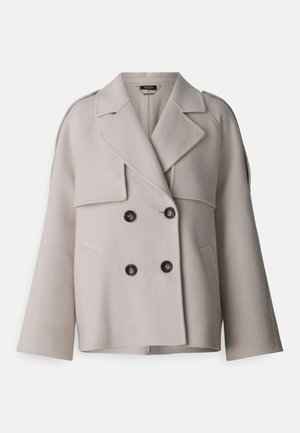 Cappotto doppiopetto in misto lana color beige chiaro, con rever a punta, due ampie tasche frontali e chiusura con bottoni. Sottolineato da maniche ampie.