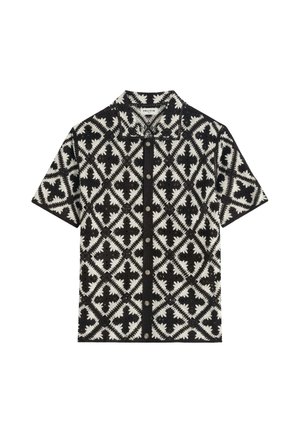 Chemise à manches courtes boutonnée avec motif géométrique losange noir et blanc et col.