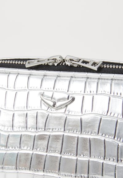 Silver zippered clutch bag with crocodile-patterned texture and a black fabric lining. Features a metallic logo accent above the zipper.