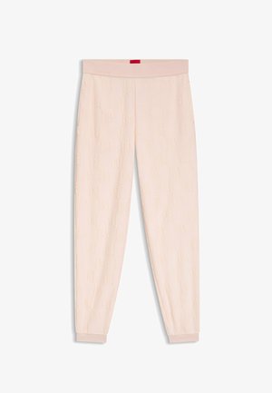 Light pink sweatpants with a textured pattern and elastic waistband. Cuffs at the ankles and a small red label on the back of the waistband.