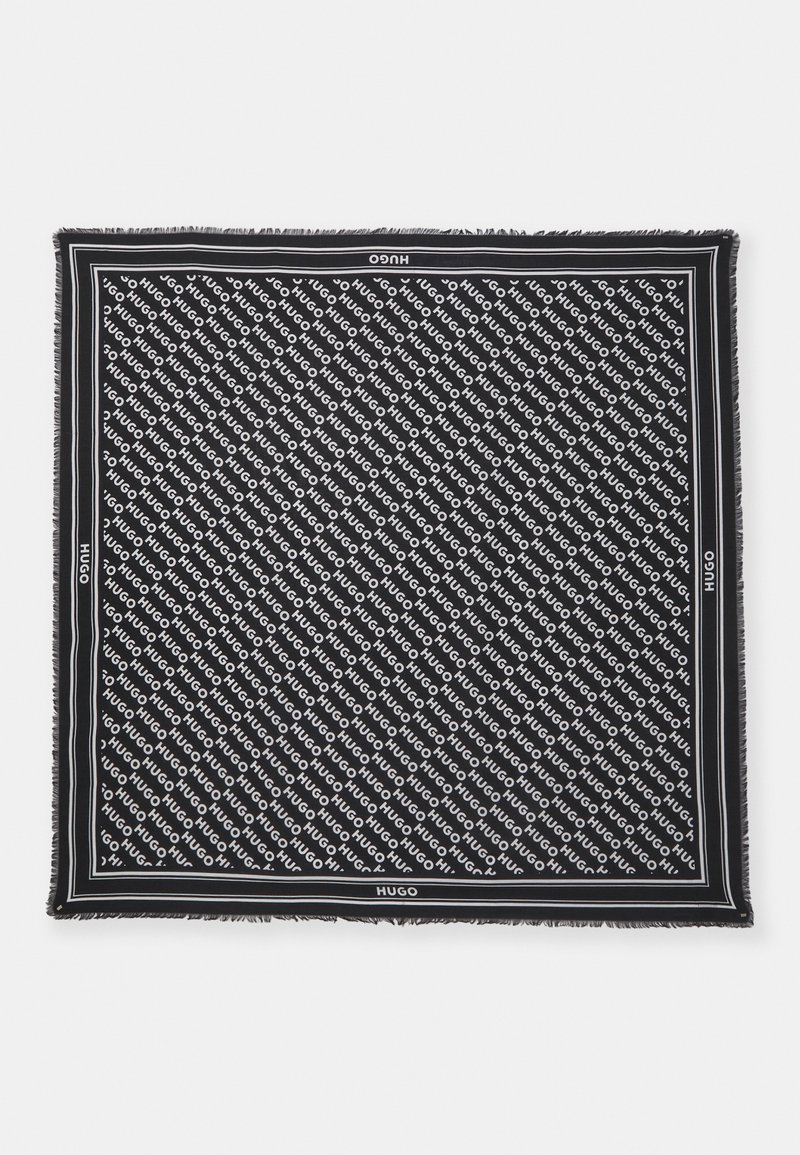 Black scarf with repeated white "HUGO" text. Fringed edges and thin white borders create contrast. Soft fabric with a flat texture.