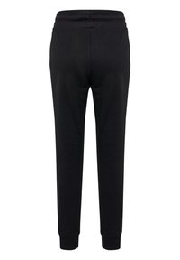 Schwarze Jogginghose mit einer weichen Textur, tapered Fit, elastischem Bund und gerippten Bündchen. Einfaches Design ohne zusätzliche Muster oder Akzente.