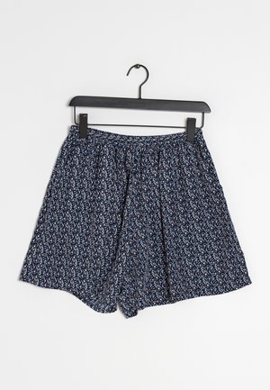 Blue patterned shorts on a black hanger. The fabric features small floral designs in white, red, and navy, with an elastic waistband.