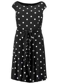 Musta mekko valkoisilla pilkuilla, hollantilaisilla hihoilla ja tiukalla vyötäröllä, jossa solmittava vyö. Laajahelmainen hame, jossa sileä kankaan rakenne.