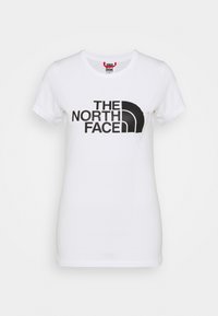 Bílý bavlněný tričko s velkým černým logem s textem "THE NORTH FACE." Kulatý výstřih a krátké rukávy s hladkou texturou.