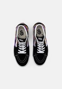 Black suede sneakers with multicolored geometric patterns, white laces, and contrasting stitching. Signature Vans logo visible inside.