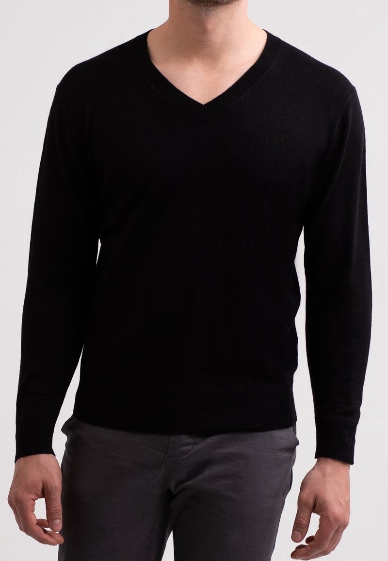 Schwarzer V-Ausschnitt-Pullover mit langen Ärmeln, aus einem weichen Material gefertigt. Verfügt über eine figurbetonte Passform sowie gerippte Bündchen und Saum.