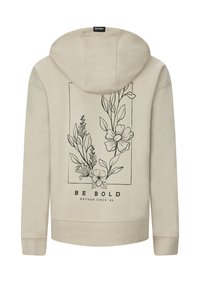 Felpa beige con arte lineare botanico nero inquadrato sulla schiena, con fiori e foglie, e il testo "BE BOLD RETOUR SINCE '89" sotto.