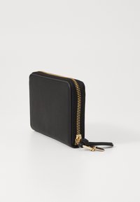 Black leather wallet with a square design, gold zipper, and zipper pulls. Smooth texture with minimal visible branding or embellishments.
