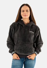 Grijze corduroy hoodie met een voorzak, trekkoordcapuchon en wit logo. Beschikt over zwart-witte gestreepte boorden. Casual fit.