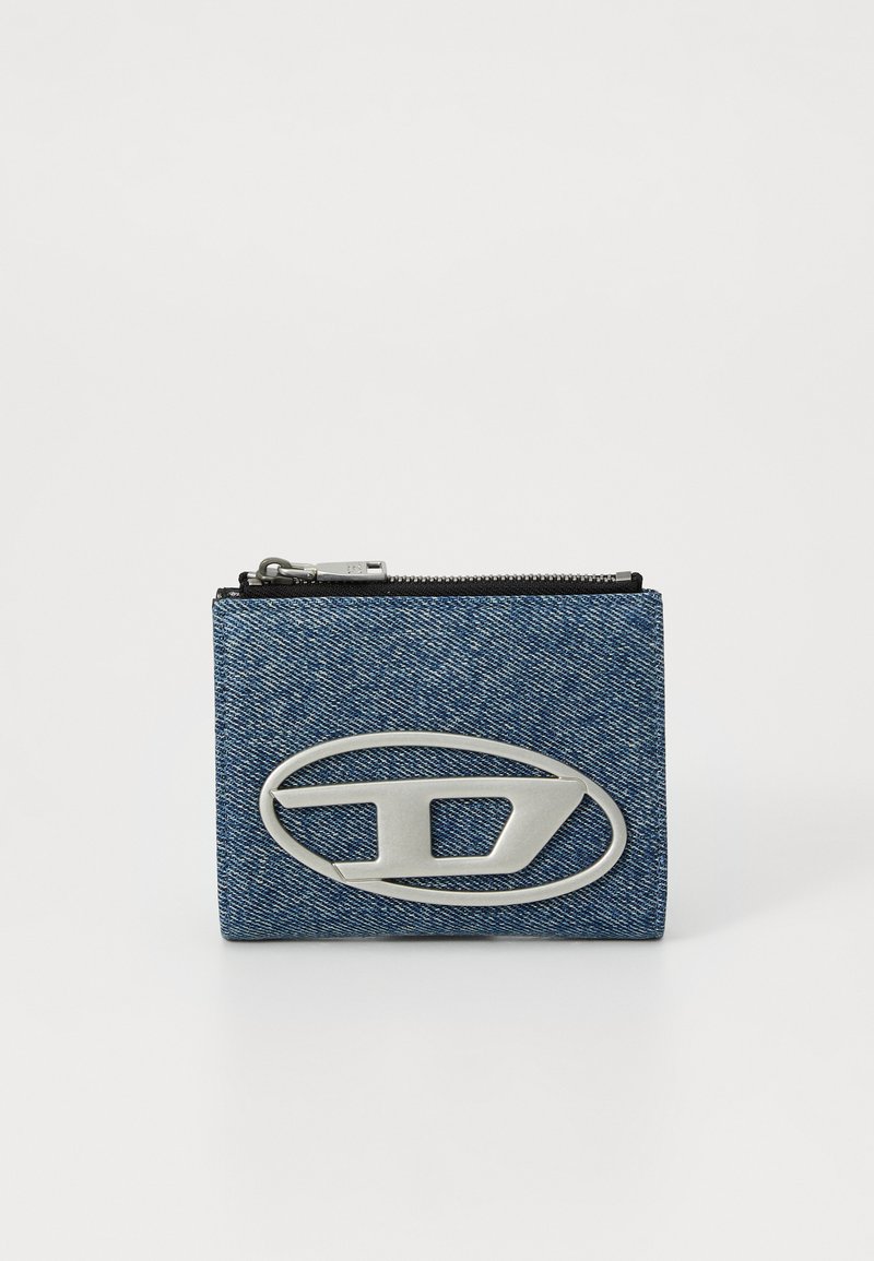 Portafoglio in denim con logo argentato, chiusura con zip, forma rettangolare, tessuto blu testurizzato e dettagli di cucitura visibili.