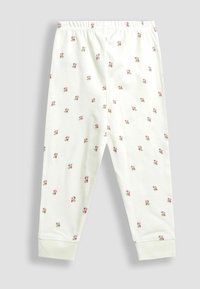 Biele nohavice pre batoľa s malým kvetinovým vzorom v ružovej a zelenej farbe, elastickým pásom a s manžetami na členkoch.