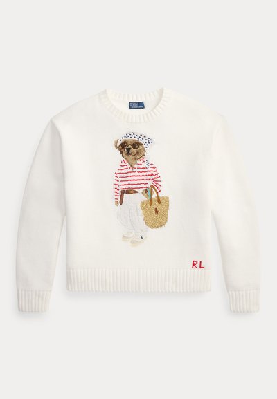 White sweater with a dog wearing sunglasses, a red striped shirt, white pants, a hat, and holding a tan tote bag embroidered on front.