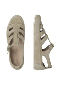 Chaussures en suédine beige à enfiler avec découpes, sangles croisées et semelles en caoutchouc blanches. Elles disposent d'une fermeture éclair latérale pour un enfilage facile.