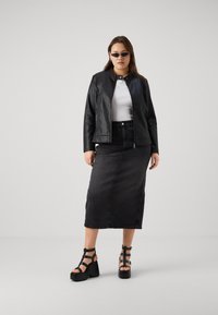 Black leather jacket, white fitted top, black denim midi skirt, and chunky black platform sandals with straps. Simple, sleek design.