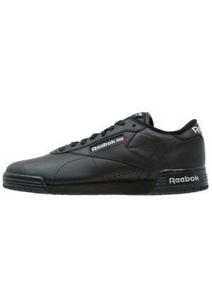Black low-top Reebok sneaker with lace-up design, leather upper, and Reebok logos on side, heel, and tongue.