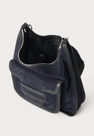 Dark blue suede shoulder bag with black leather trim, an open main zipper compartment, and an external front pocket with flap.