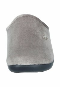 Gray suede slip-on shoe with a rounded toe, black rubber sole, and a small silver emblem on the upper side. Smooth texture throughout.