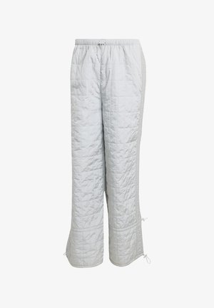 Pantaloni trapuntati grigi chiari con vita elasticizzata, fessure laterali e cordoncini regolabili all'orlo. Finitura liscia e strutturata.