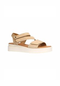 Beige suede sandals with two adjustable straps and a wide toe opening, featuring a white chunky sole and brown footbed.