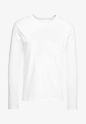 Langærmet hvid t-shirt lavet af blød bomuld. Rund halsudskæring med lige skårne kanter og ingen synlige mønstre eller grafikker.
