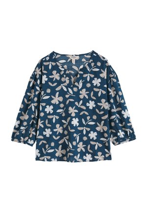 Modra bluzica s bež in belimi cvetnimi vzorci, z V-izrezom in rokavi do tri četrtine.