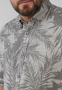 Grijs overhemd met knopen, voorzien van een witte palmbladpatroon, korte mouwen en een klassieke kraag; gemaakt van lichtgewicht stof met een gestructureerde feel.