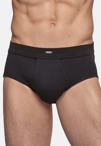 Black men's briefs made from cotton, featuring a fitted design, elastic waistband, and stitch detailing. No patterns or logos visible.