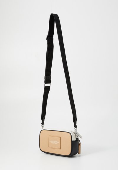 Small rectangular bag with beige, black, and white leather sections. Features a textured finish, silver hardware, and a detachable black strap.