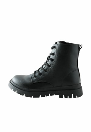 Black leather lace-up combat boot with thick treaded sole and pull tab on the back, shown from the side on white background.