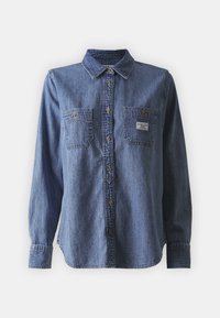 Blue denim long-sleeve shirt featuring a button-down collar, two chest pockets, classic fit, and subtle texture. Label on left pocket.
