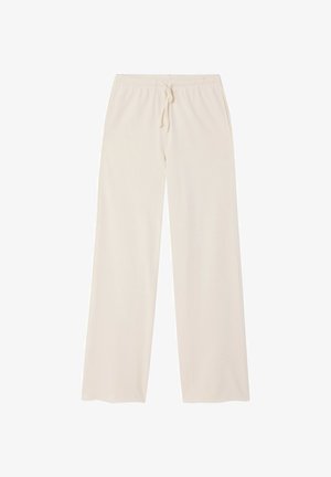 Light beige, loose-fitting, wide-leg pants with an elastic waistband and adjustable drawstring, made from a soft fabric texture.