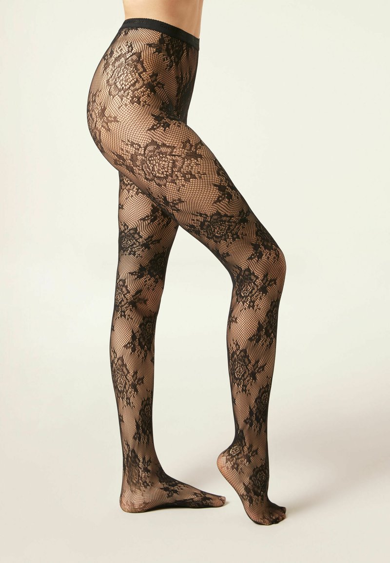 Collants en résille noirs avec un motif floral en dentelle délicat, texture transparente et taille solide, mettant en valeur la peau en dessous.
