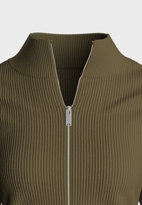 Haut en tissu côtelé vert olive avec col haut et fermeture éclair frontale dotée d'un tirette métallique. Texture lisse avec des rayures verticales.
