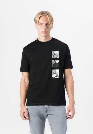Black cotton t-shirt featuring a vertical graphic of three black-and-white portraits, text reading "KARL LAGERFELD" below the images.