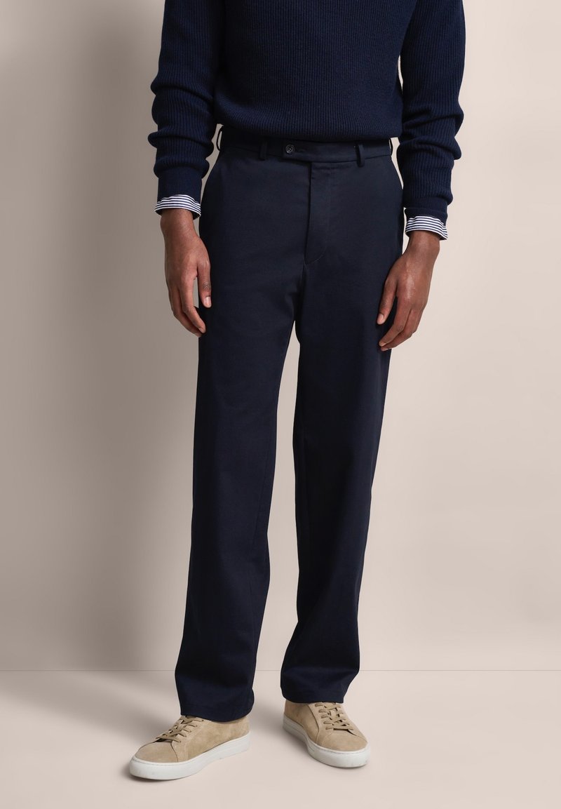 Navy blue trousers made from lightweight fabric, featuring a straight leg design and a classic waistband. Smooth texture and minimal detailing.