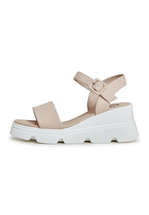 Beige platform sandals with an open toe, wide straps, and adjustable ankle buckle. White chunky sole with a textured finish.