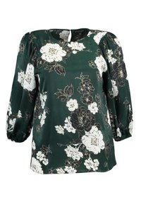 Green floral blouse with long puff sleeves, V-shaped neckline, and black and white flower patterns on a smooth, silky fabric.