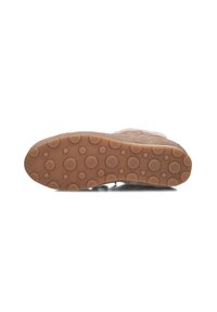 Tan suede shoe sole with a patterned, textured rubber bottom featuring circular raised dots for enhanced grip and flexibility.