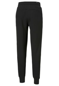 Sorte sweatpants med en ribbet talje, tapered ben og elastiske manchetter. Lavet af et glat stof med minimal syning.
