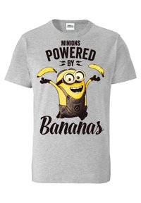 Gray cotton T-shirt featuring a cartoon Minion character with large eyes, wearing overalls, and holding two bananas; text "Minions Powered by Bananas."