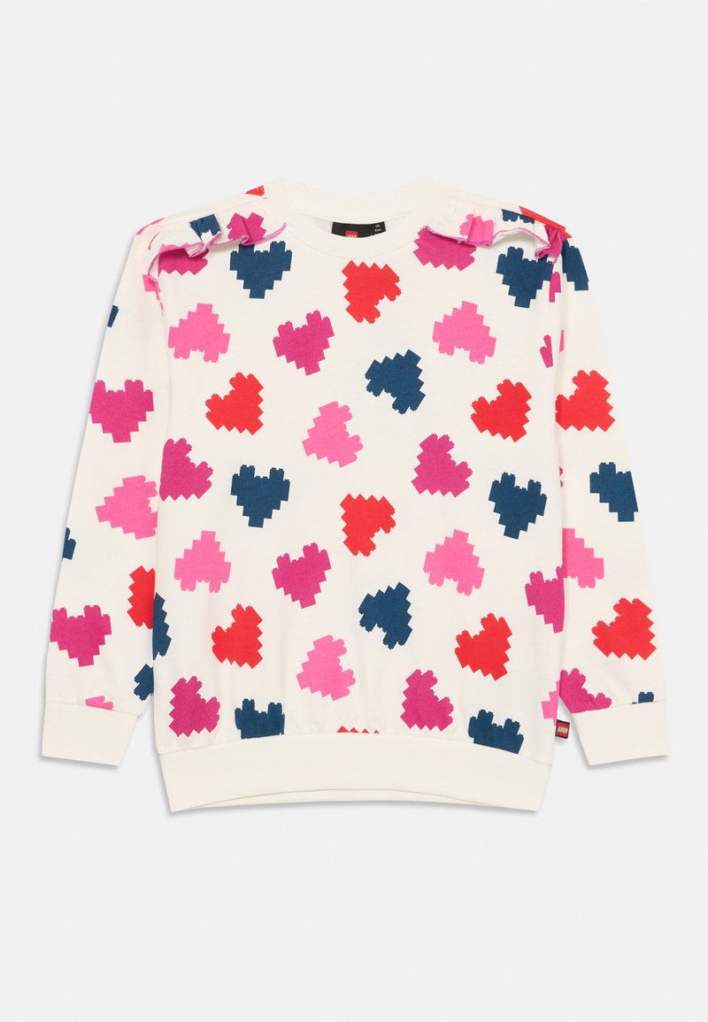 Sudadera blanca con grandes corazones pixelados en rosa, rojo y azul marino. Presenta volantes en los hombros y puños acanalados en el dobladillo y las mangas.