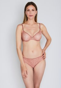Lace bralette and matching brief set in dusty rose. The bra features a floral pattern, underwire support, and adjustable straps.