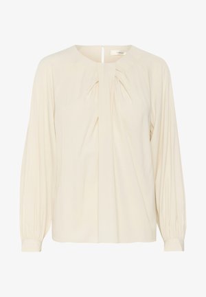 Krémová blúzka s dlhými, zhromaždenými rukávmi, skladaným predným dizajnom a otvorom v tvare kľúčovej dierky na chrbte. Hladká textúra látky.