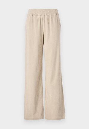 Pantalons larges en velours côtelé beige avec une taille élastique et une texture à côtes verticales, présentant un ourlet qui s'évase doucement au bas.