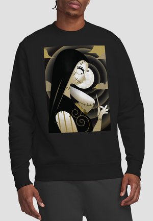 Black sweatshirt featuring a central graphic of a cartoon character with a stitched face, long black hair, and gold accents.