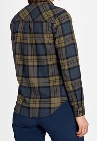 Rutig flanellskjorta med mörkgrön, blå och grå färg, långa ärmar, rundad nederkant och design med bakstycke.