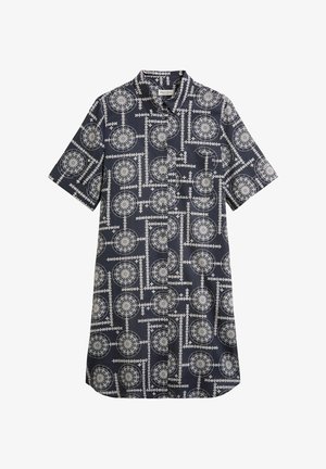 Chemise à manches courtes en tissu bleu marine avec un imprimé géométrique blanc comprenant des cercles et des lignes. Fermeture à boutons avec un col et une poche sur la poitrine.